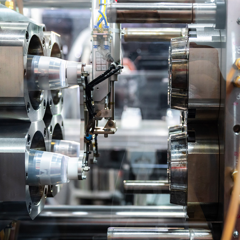 Injection moulding machine working in factory used for the forming of plastic parts using plastic resin and polymers.